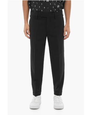Pantalones ajustados de cintura regular con cremallera en el tobillo en negro