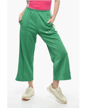 Pantalones acampanados deportivos con bandas laterales en contraste en verde