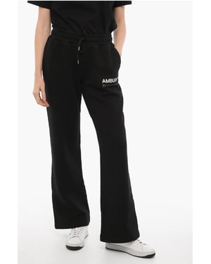 Pantalones deportivos de color liso con logotipo estampado en negro