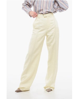 Pantalones de lino puro con pinzas delanteras bordadas en amarillo