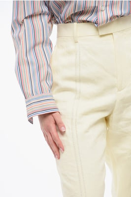 Pantalones de lino puro con pinzas delanteras bordadas en amarillo