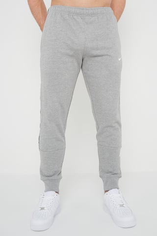 Nike Joggers de polar con puños y logo repetido en gris para hombre