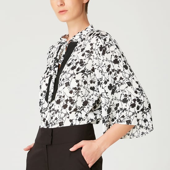 Tulip sleeves blouse with monochrome floral print and contrasting neckline