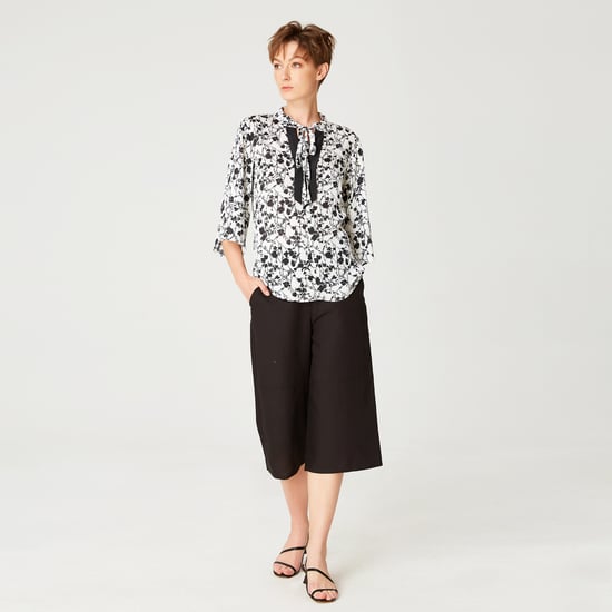 Tulip sleeves blouse with monochrome floral print and contrasting neckline