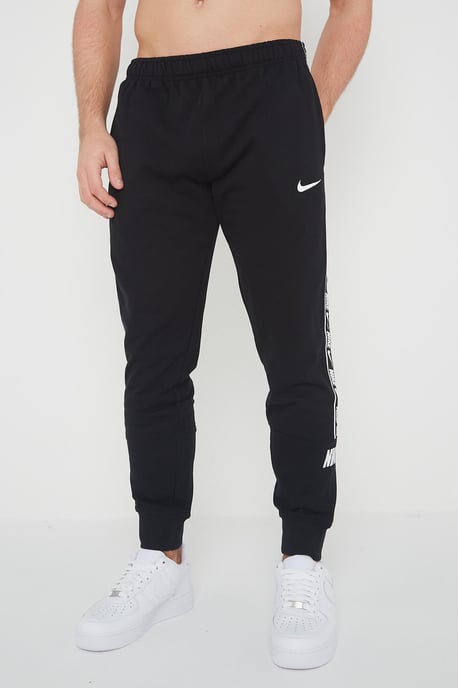 Nike Joggers de polar con puños y logo repetido en negro para hombre - Image 1