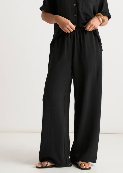 Pantalones negros elásticos de cintura ancha y pierna ancha - Image 2